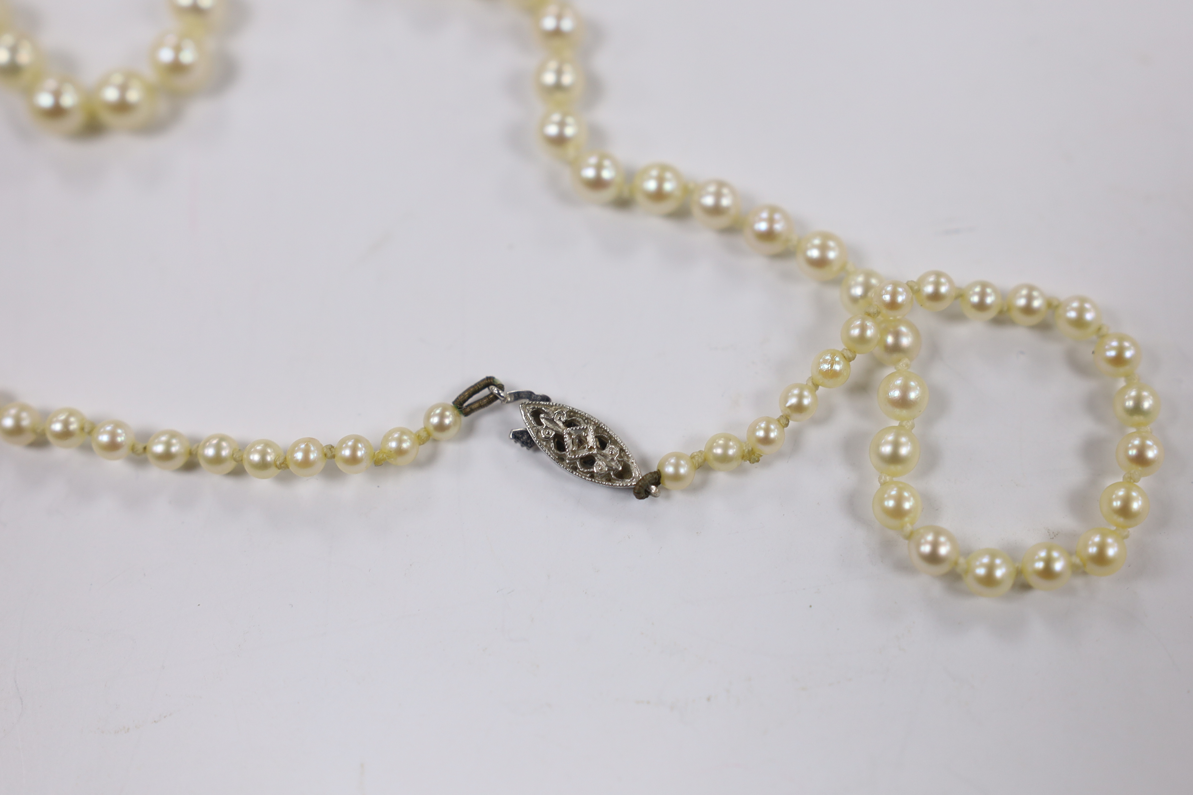 A 1960's single strand graduated cultured pearl necklace with diamond chip set 9ct white gold clasp, 50cm.